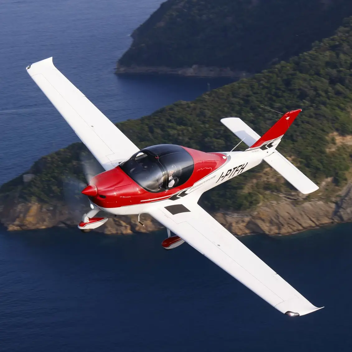 Factory-fresh single-engine airplane flying in clear blue skies