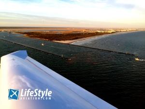 DA40 Flying over beach at sunset